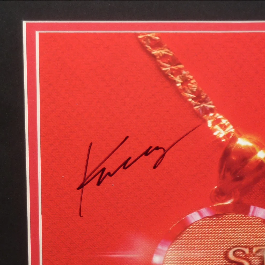 Kacey Musgraves autographed deluxe framed vinyl with gold poker chip necklace on red background