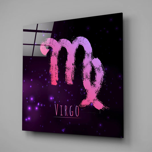 Angled view of glass wall art displaying pink brushstroke Virgo zodiac symbol on purple nebula background with glowing stars.
