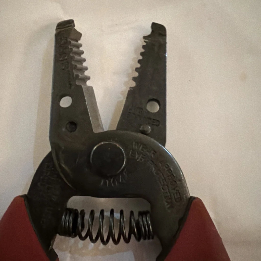 Klein Tools wire stripper cutter pliers with red handles, serrated jaws