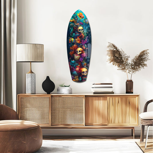 Surfboard-shaped glass wall art featuring colorful underwater coral, tropical fish, and golden skulls displayed above a wooden mid-century credenza in a modern living room.