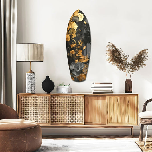 Gold leaf floral surfboard panel displayed on white wall above wooden mid-century credenza in modern living room setting.