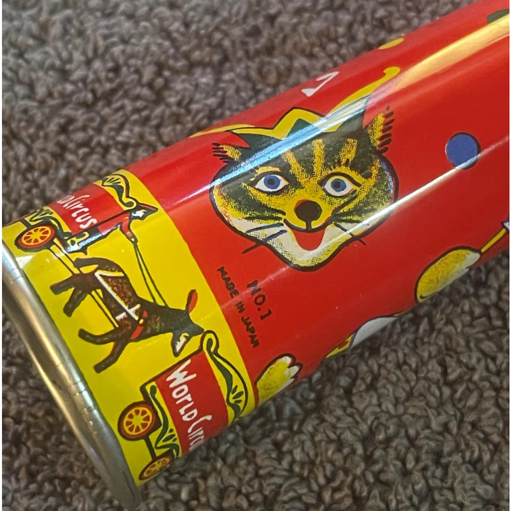 Colorful vintage tin horn noisemaker with fun cartoon cat designs from the 1960s