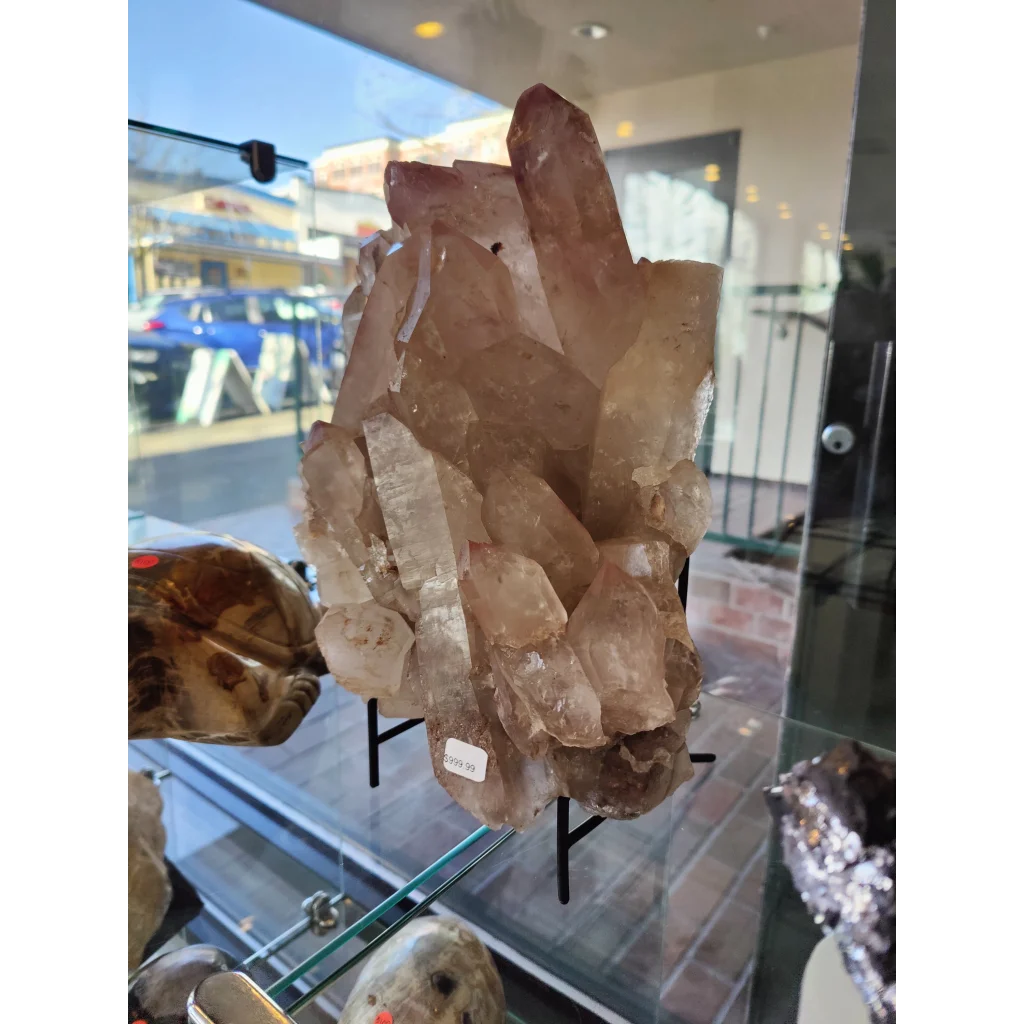 Lithium quartz cluster weighing 7.55kg featuring translucent amber-hued quartz cluster with sharp pointed formations