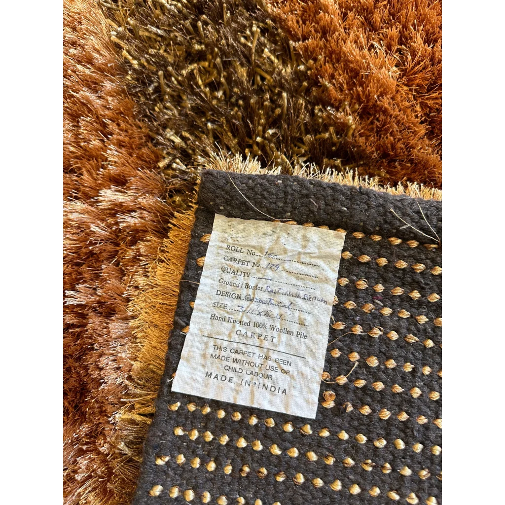 Shaggy striped wool rug in earthy browns, golds and grays with plush deep pile