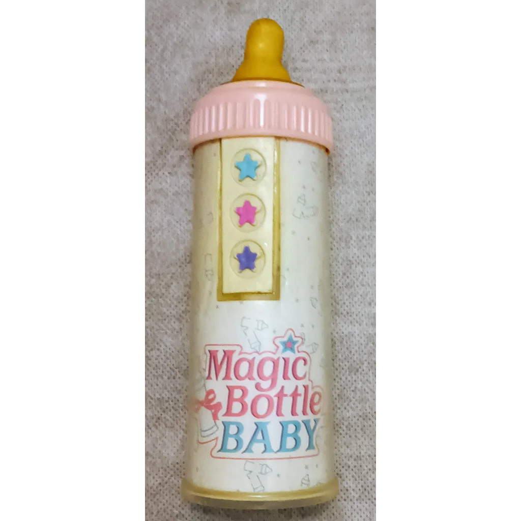 Vintage 1990 Tyco Magic Bottle baby bottle in pink yellow with stars
