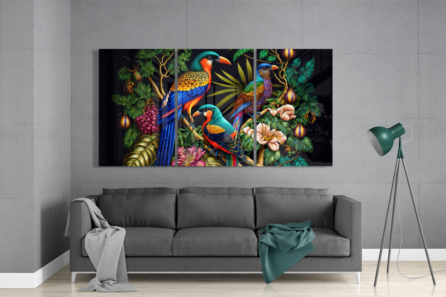 Colorful glass wall art depicting three tropical parrots among flowers and foliage displayed above a gray sofa in a minimalist interior.