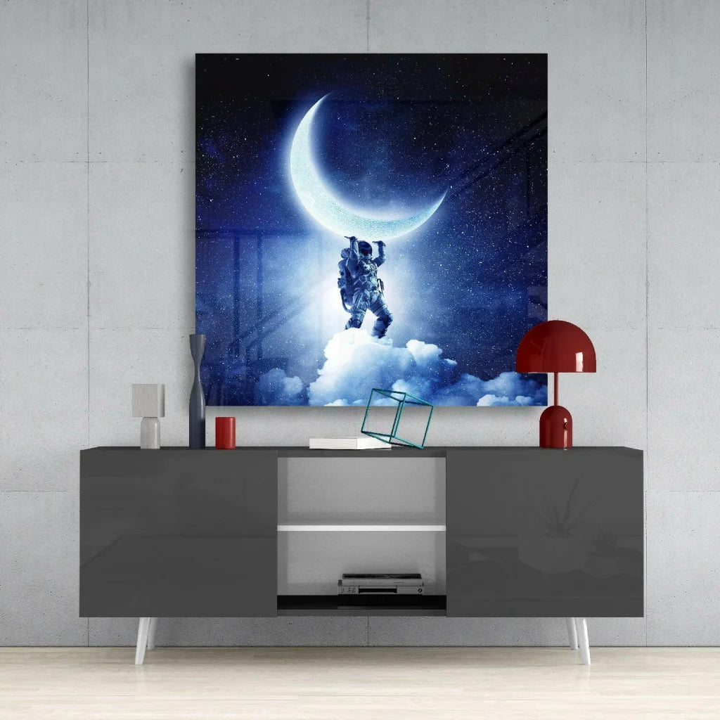 Astronaut reaching for glowing crescent moon on dreamy starry night glass wall art