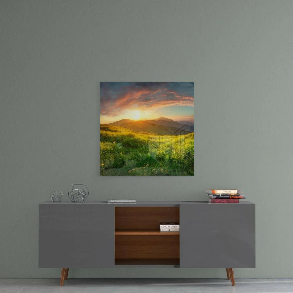 Vibrant golden sunset over green hills in glass wall art print