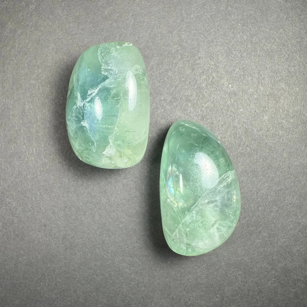 Two smooth green rainbow fluorite tumbled stones from China