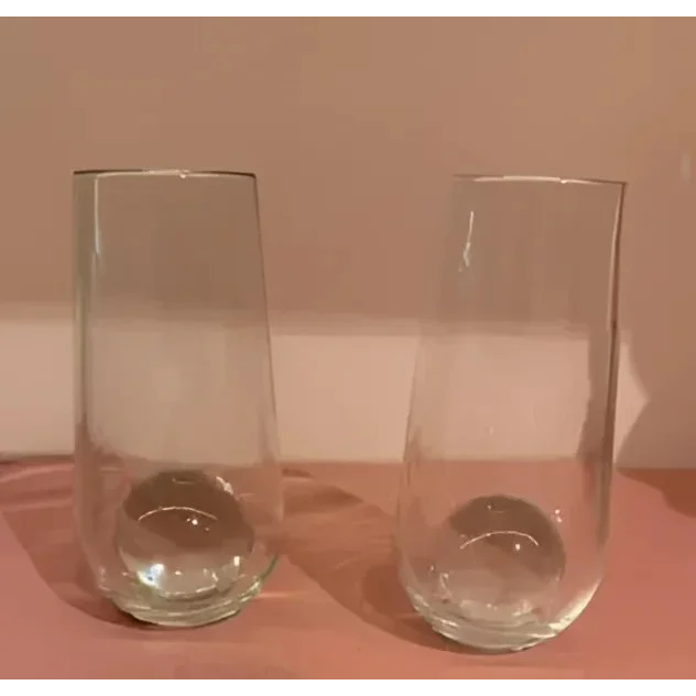 Two clear Nate Cotterman Sphere champagne flutes with weighted bases for toasts