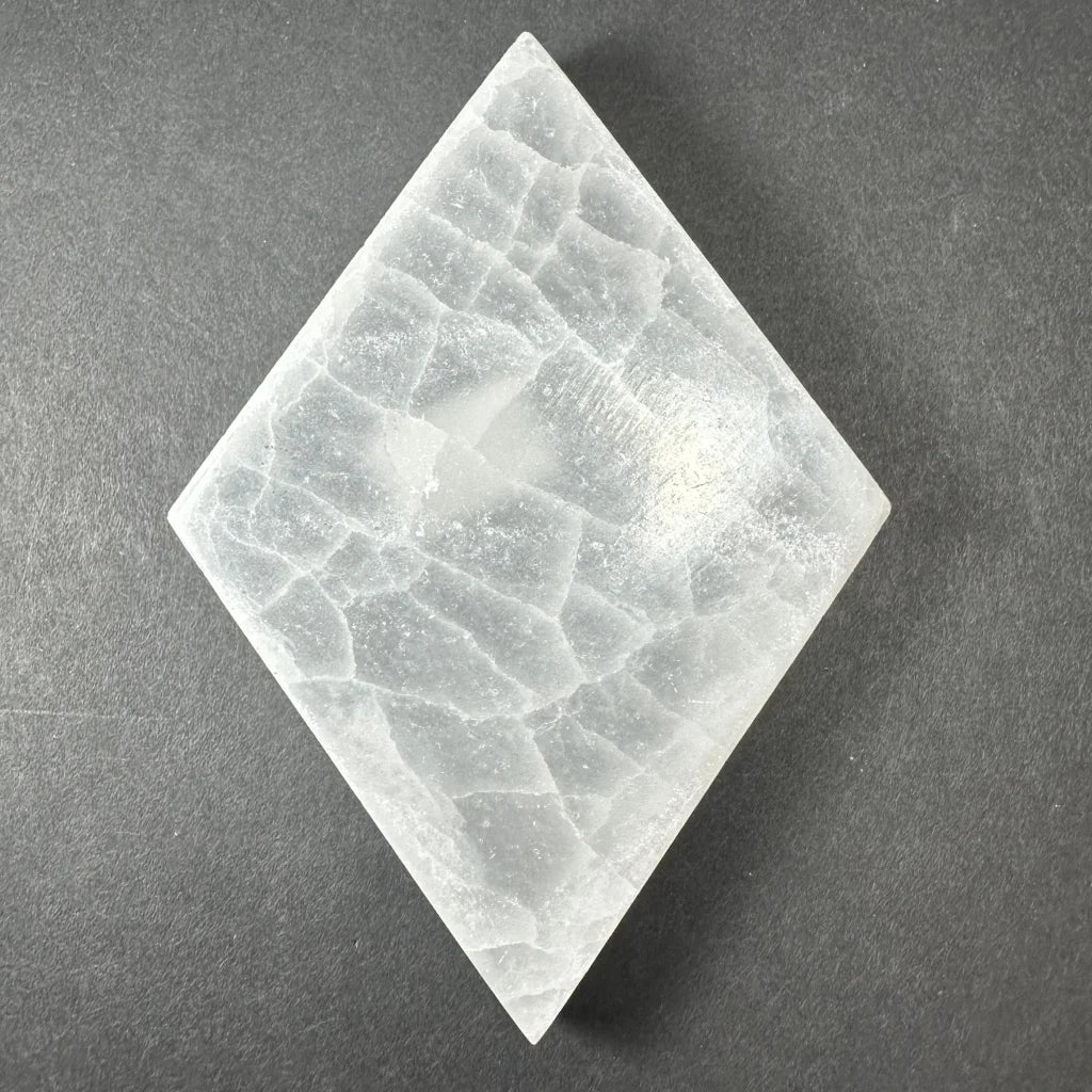 Translucent diamond-shaped selenite slice with crystalline texture