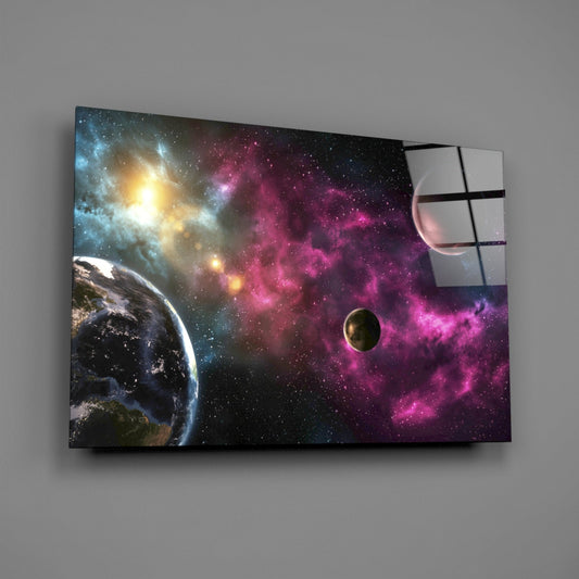 Angled view of glass wall art displaying planets and magenta nebula clouds against starfield, mounted on gray wall.