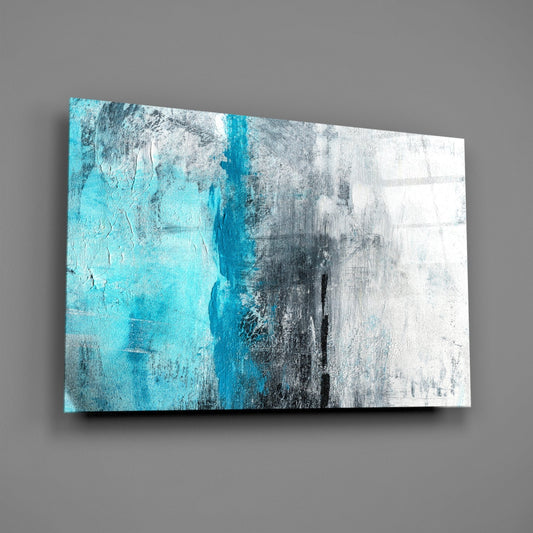 Modern abstract glass wall art featuring turquoise vertical stripe dividing gray and white textured sections, displayed at an angle against gray wall.
