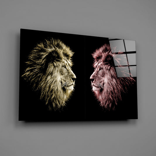 Multi-panel glass wall art displaying two lion heads in profile facing each other, one in gold tones and one in pink tones against black backgrounds.