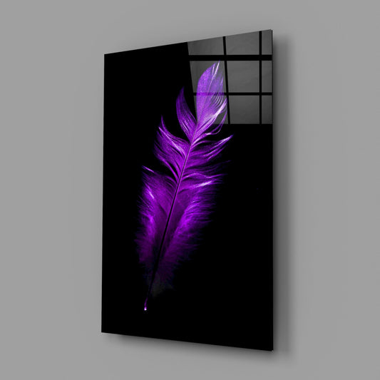 Angled perspective of black glass wall art displaying a vibrant purple feather against dark background with grid window pane overlay.