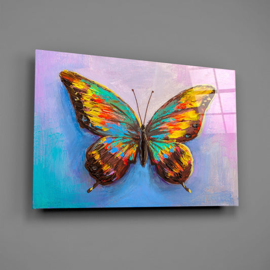 Vibrant multicolored butterfly with yellow, orange, blue, and teal wings centered on gradient pastel background displayed as glass wall art.