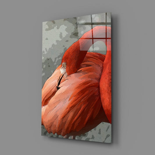 Glass wall art displaying a resting orange flamingo against a textured gray background with window pane overlay, angled three-quarter view.