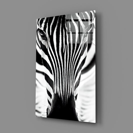 Black and white glass wall art displaying a zebra's head and neck from behind, showing symmetrical stripe patterns converging downward.