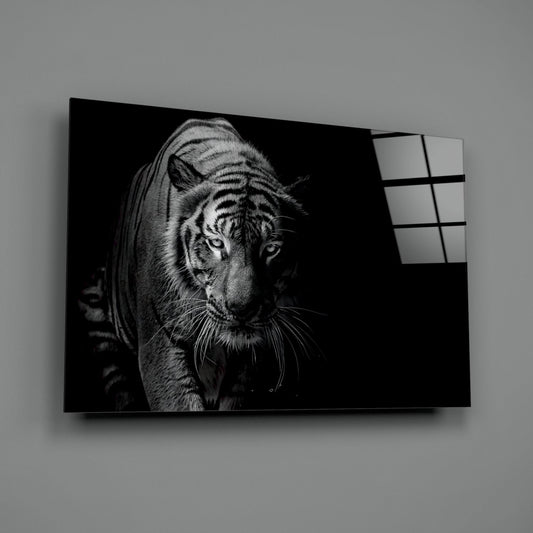 Black and white tiger portrait on dark glass panel mounted on light gray wall with grid-patterned glass sections visible on right edge.