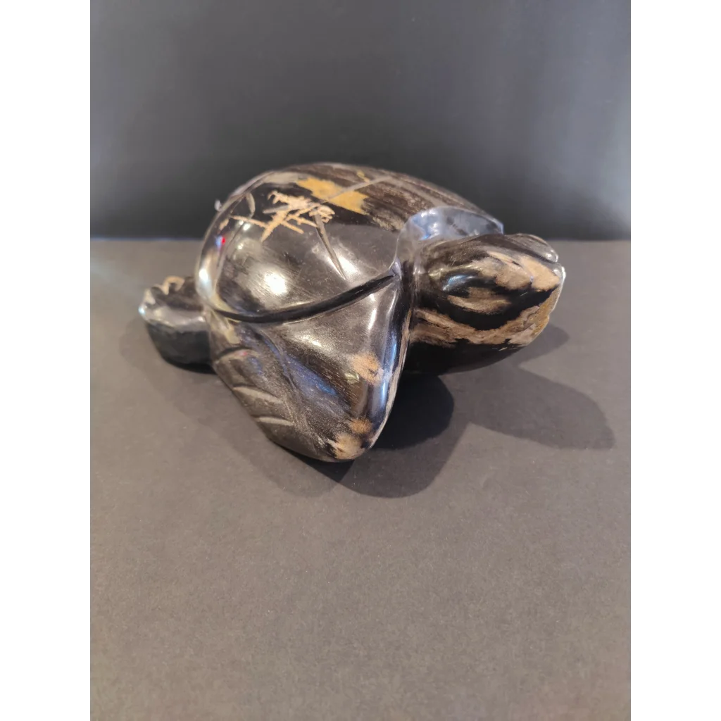 Polished black and gold petrified wood turtle sculpture with natural shell details