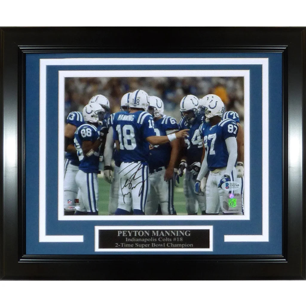 Black framed peyton manning autographed 8x10 photo of indianapolis colts in blue uniforms with white numbers by beckett
