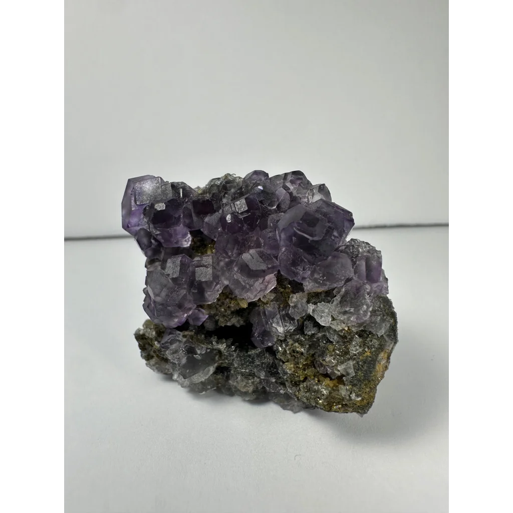 Vibrant purple dodecahedral fluorite crystal cluster from China