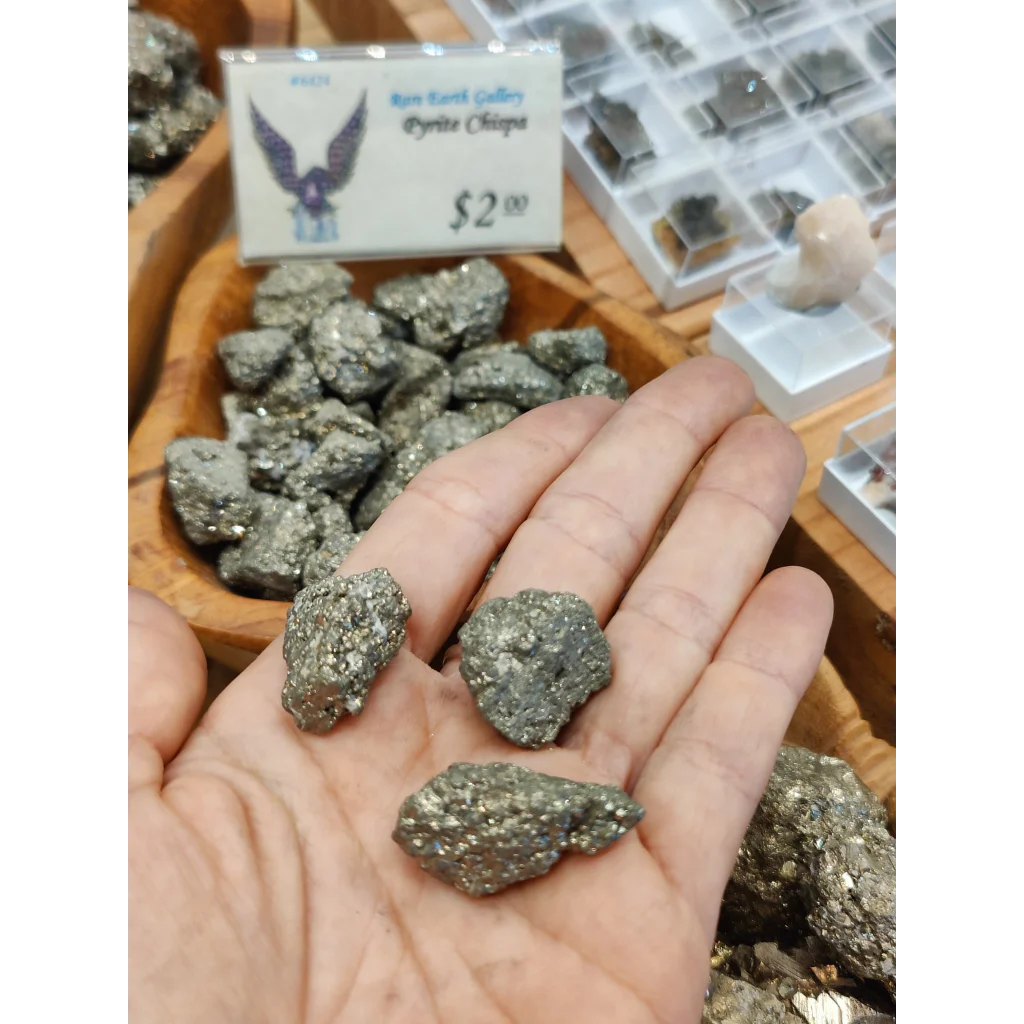 Hand holding glittering pyrite chispa chips