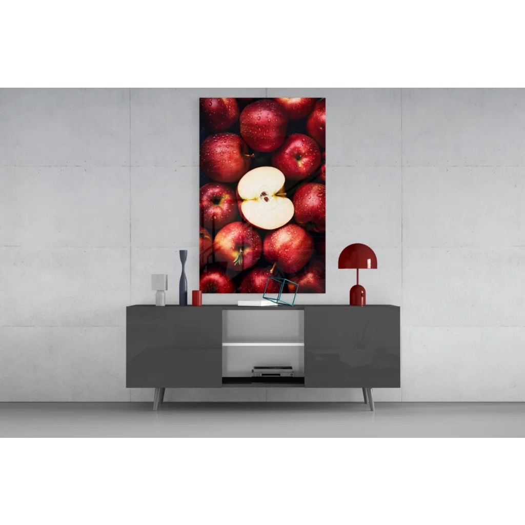 Juicy red apple glass wall art with sliced apple on canvas above gray console