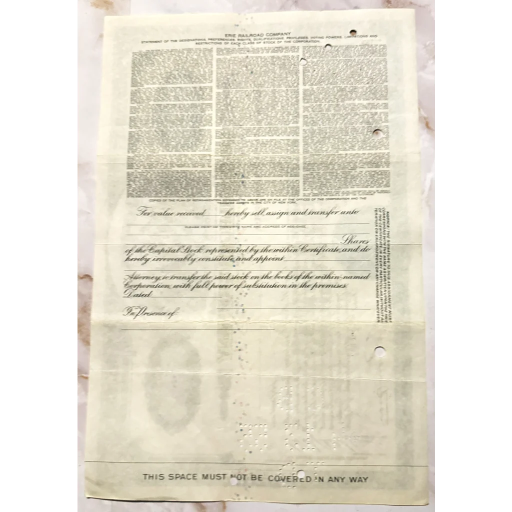 Old newspaper page with dense text and blank space from Rare 1940s Erie Railroad Stock Certificate