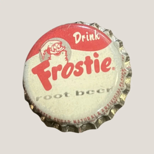 Vintage silver bottle cap with red text "Drink Frostie root beer" and elf mascot.