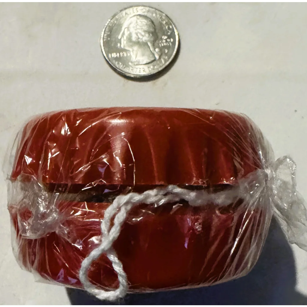 Red plastic yo-yo in plastic wrap, bottle cap shape collectible, perfect for Coca-Cola fans