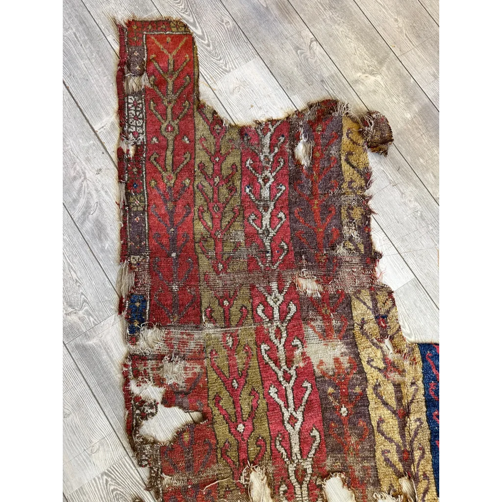 Antique Anatolian rug fragment 19th century, olive gold vine motifs on madder red, Central Anatolia