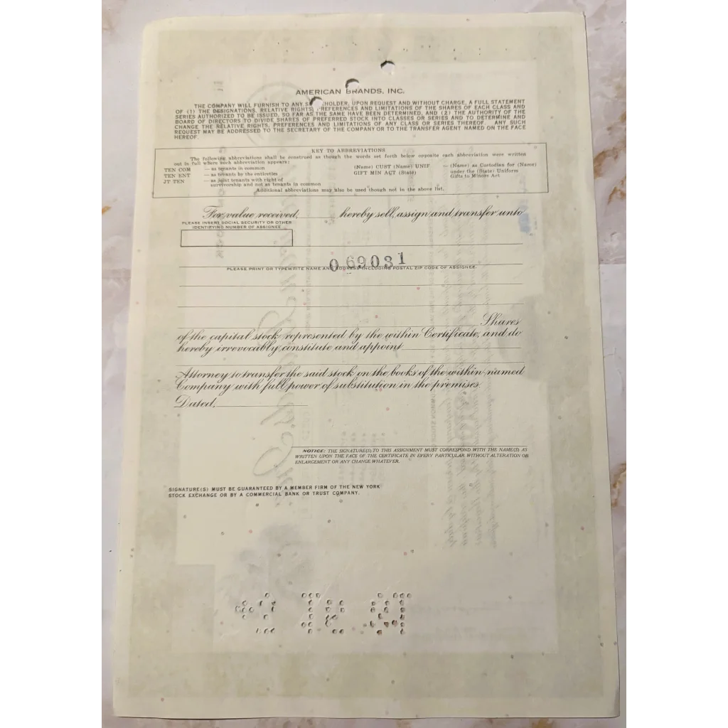 Vintage stock certificate featuring Native American art and faded handwritten details