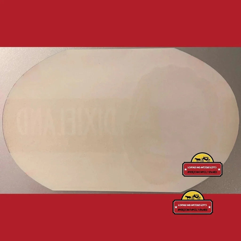 Oval-shaped pale pizza dough on a surface with Rare Antique crate label vibe