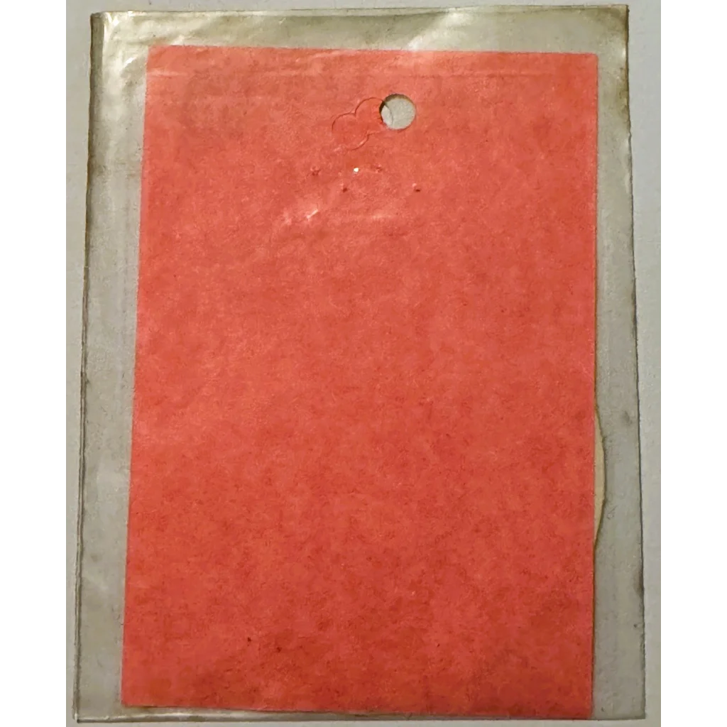 Red cardboard backing in plastic packaging for Vintage 1960s Practical Nurse emblem collectible