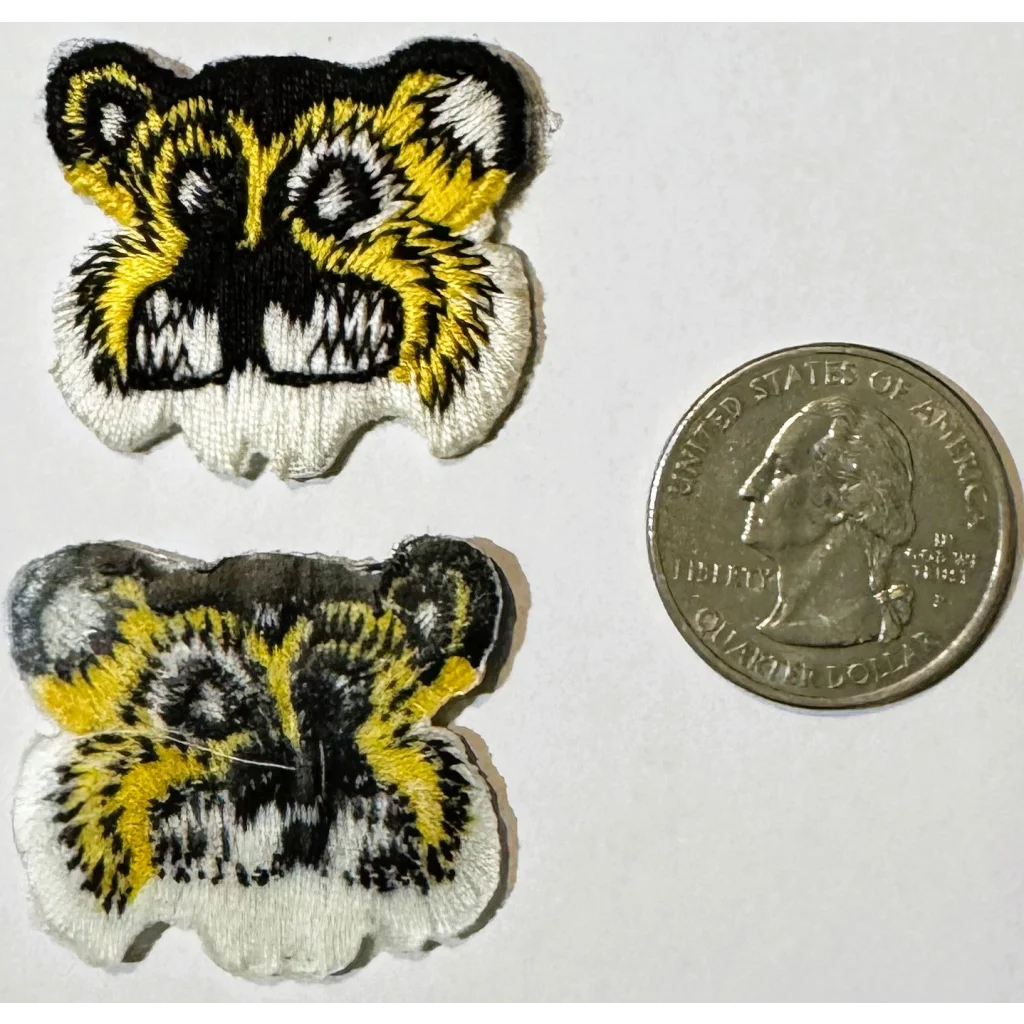Vintage embroidered tiger patches with US quarter for scale showcasing detailed design