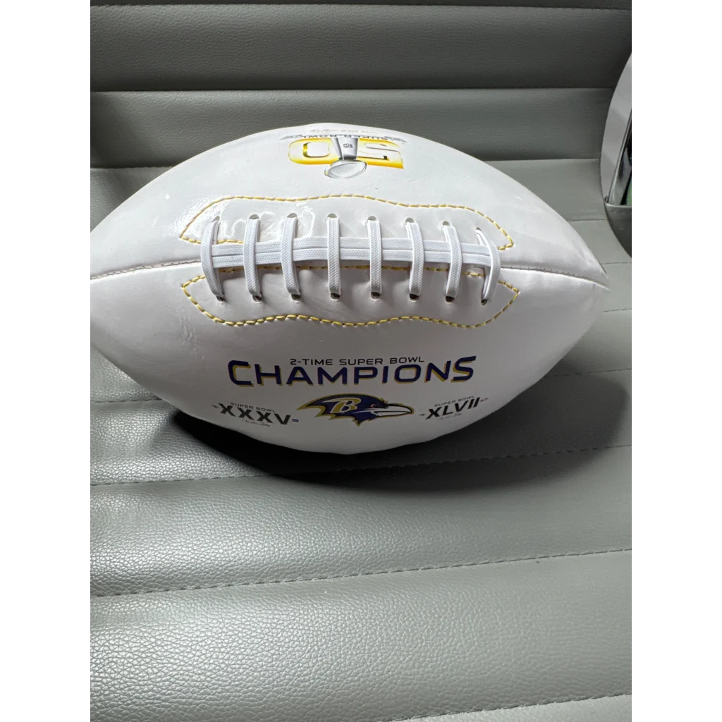 White Baltimore Ravens commemorative football with yellow stitching and laces, Ray Lewis signed team logo