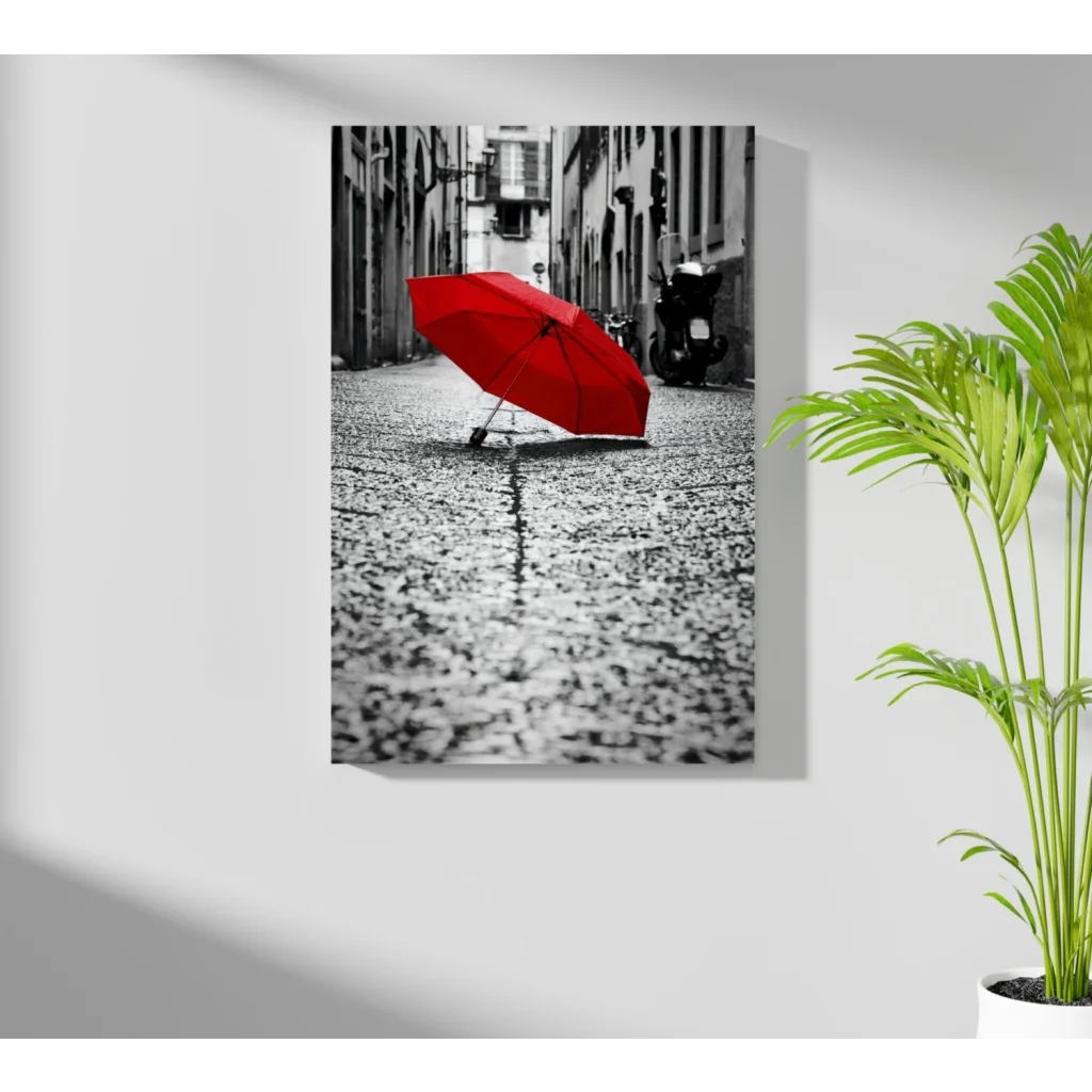 Vibrant red umbrella on wet cobblestone in black-and-white insigne aluminum print