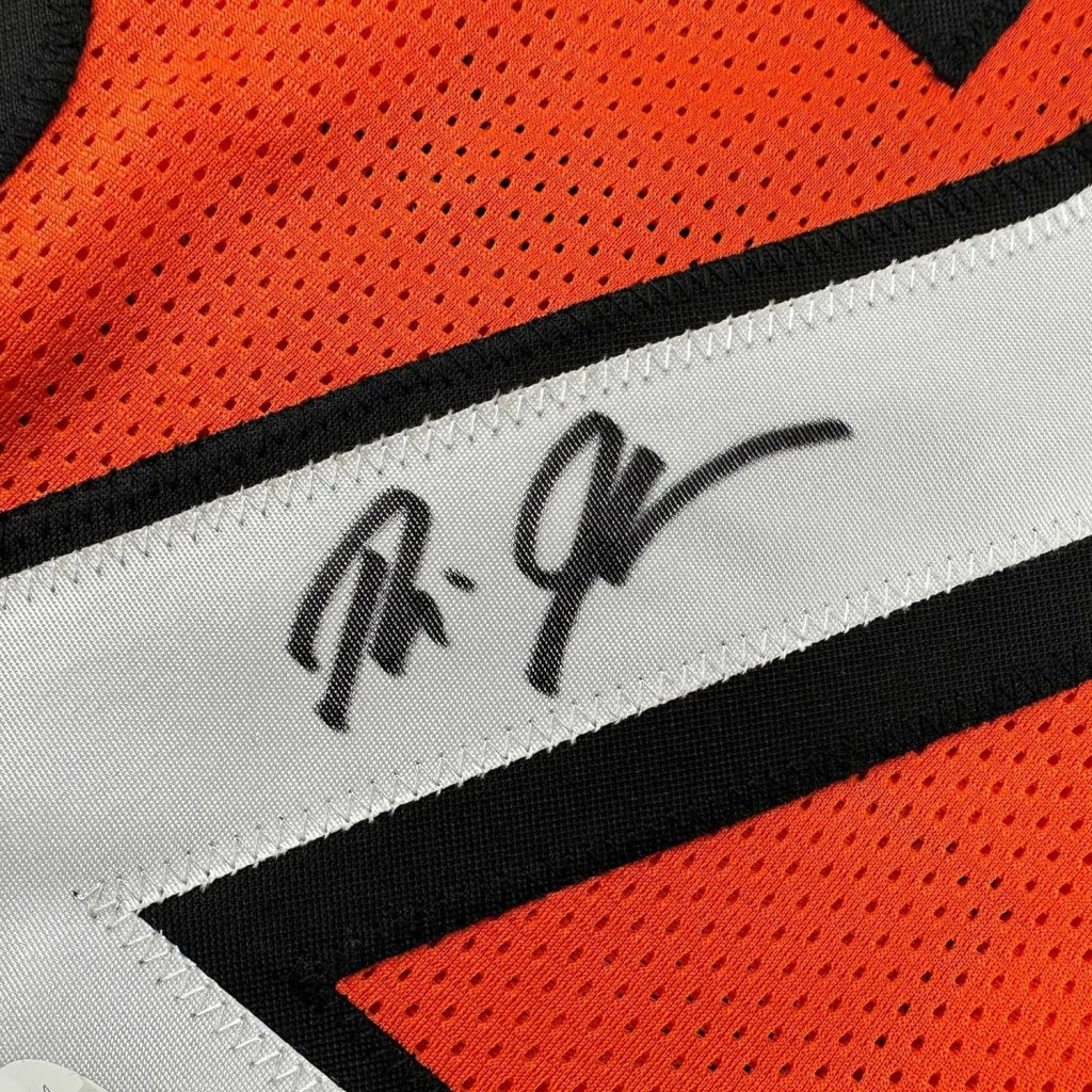 Orange mesh Bengals sports jersey with black and white stripe and Rudi Johnson autograph