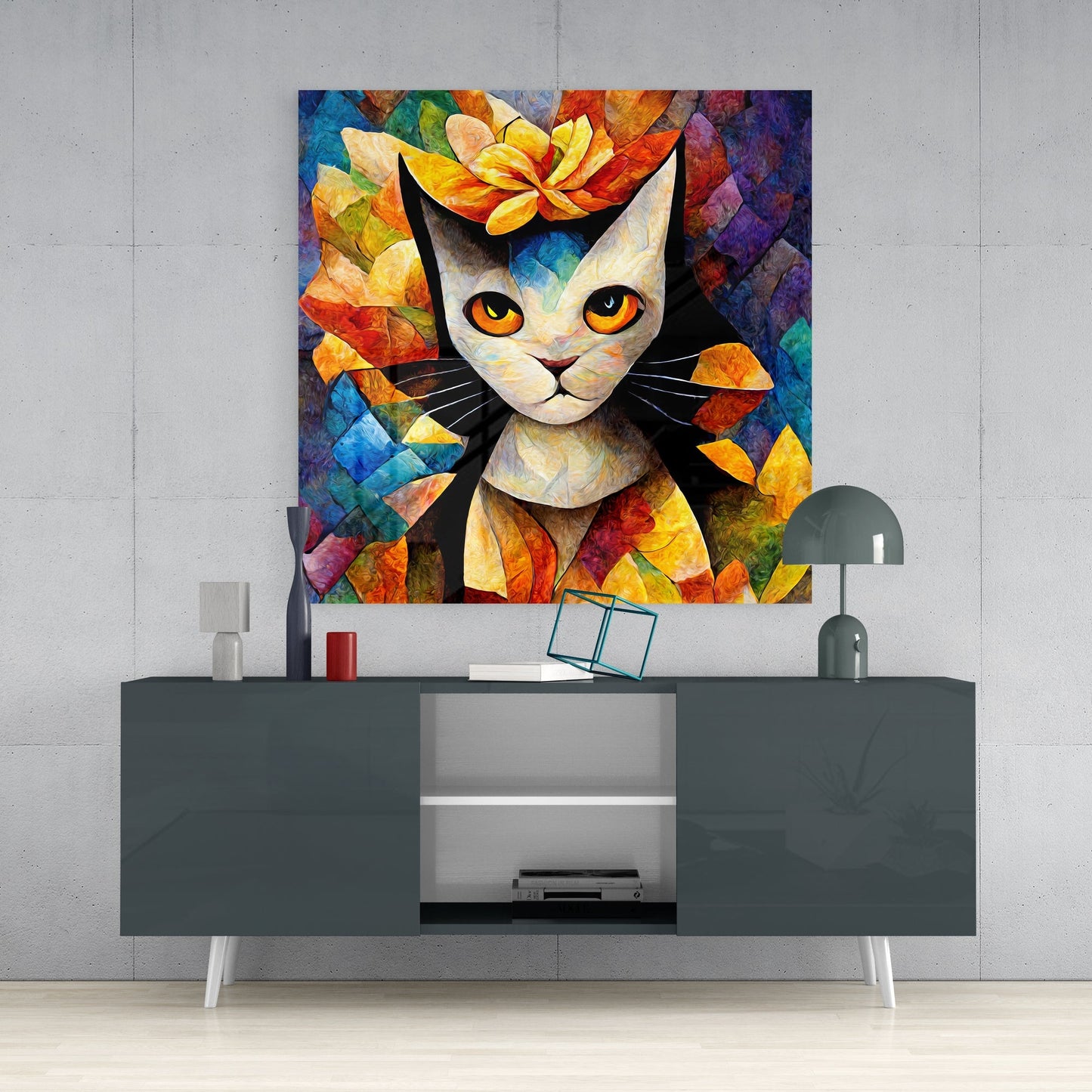 Colorful stained glass cat art with orange eyes and flower crown hanging above gray media console in modern interior setting.