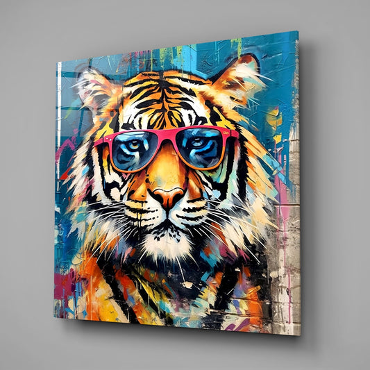 Angled front view of a colorful graffiti-style tiger wearing pink sunglasses on a glass panel against gray background.