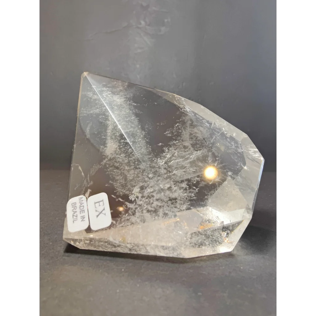 Smoky clear quartz polished free form sculpture featuring clear quartz with internal inclusions made in brazil