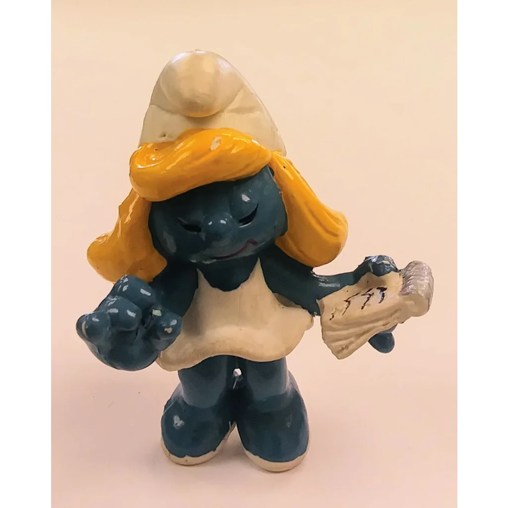 Vintage 1981 Secretary Smurfette Peyo Schleich ceramic figure with yellow hat and apron holding newspaper