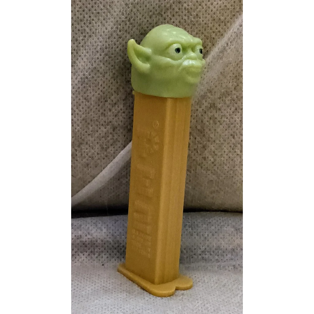 Vintage Star Wars Yoda Pez dispenser with green body and yellow base