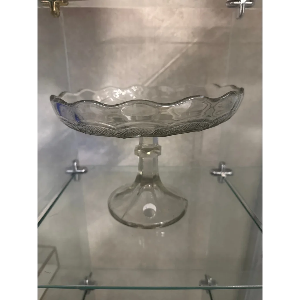 Clear glass clake serving stand with scalloped edge and embossed pattern for elegant dining