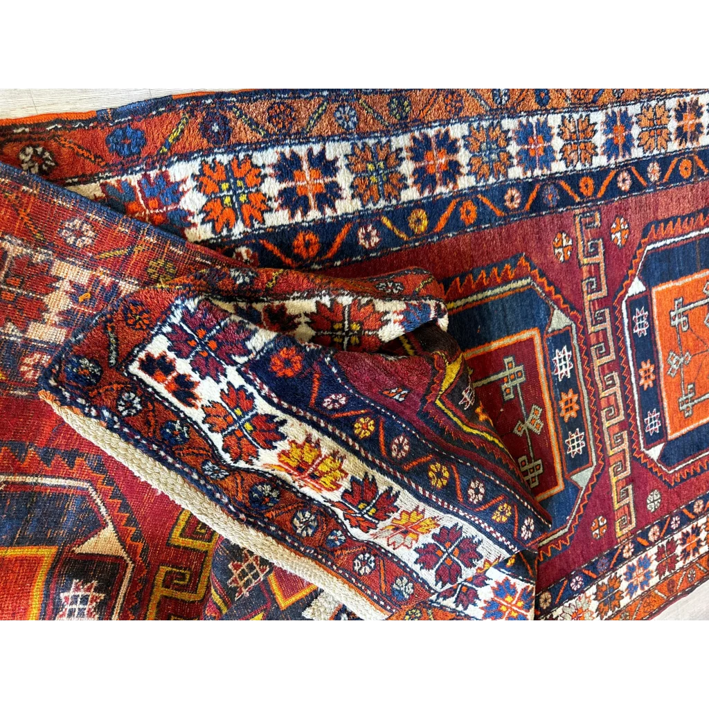 Vibrant Kurdish Kazak wool pile geometric motifs runner with floral patterns