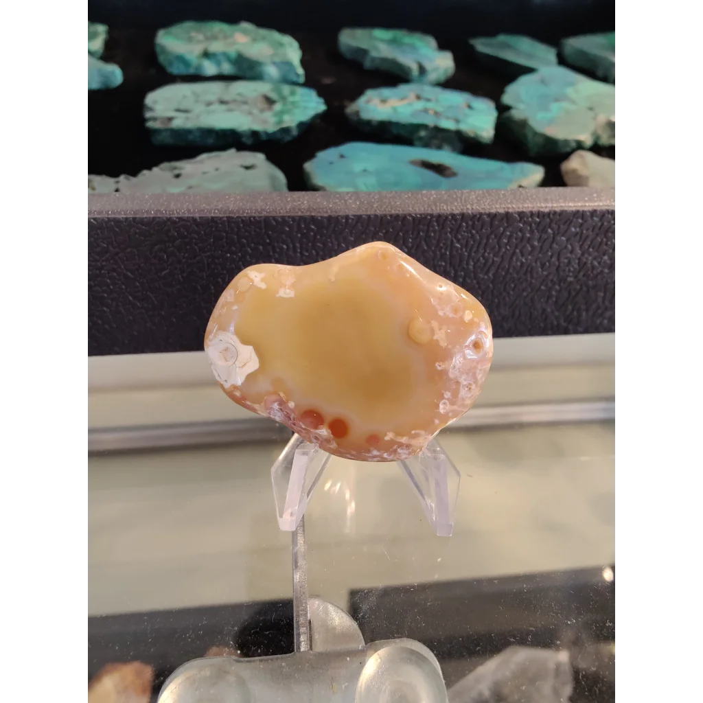 Polished orange agate gem with red inclusions