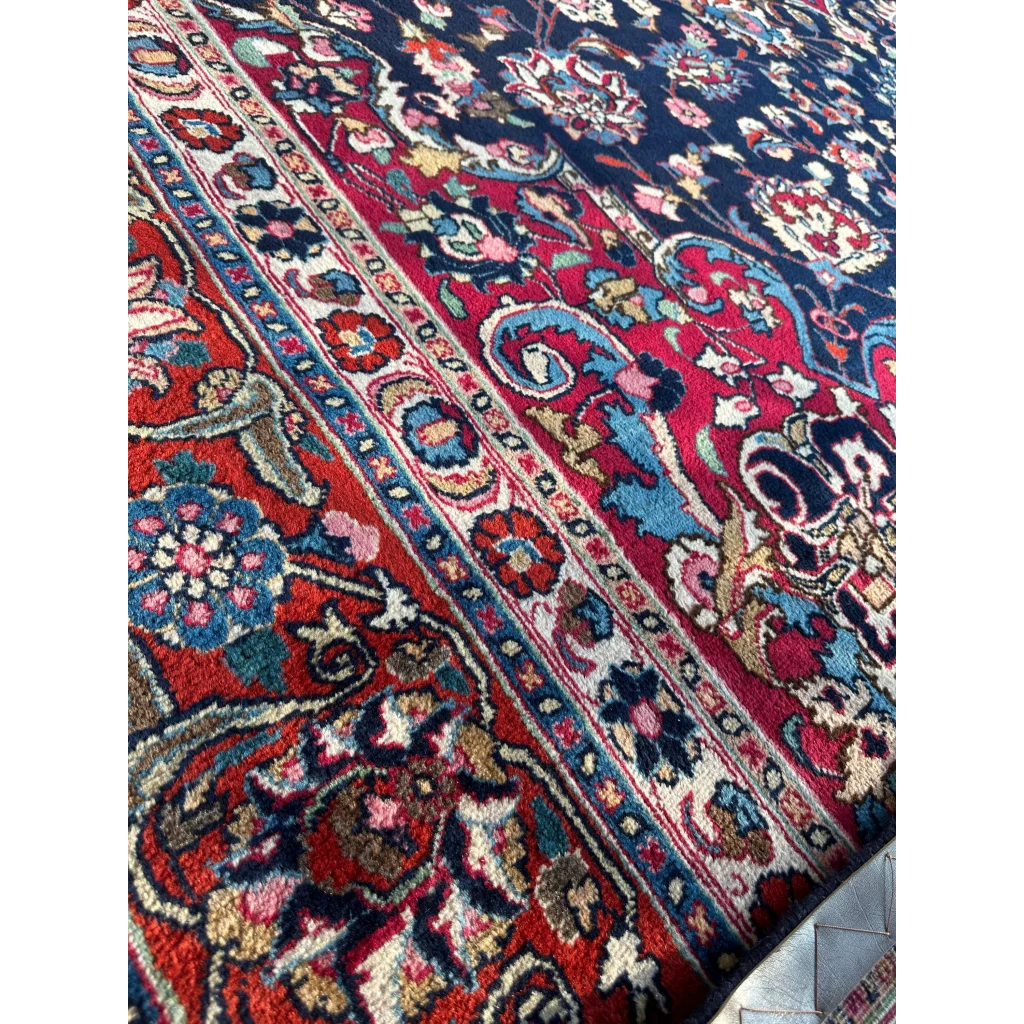 Stunning Persian Mashhad hand knotted wool area rug with intricate floral paisley patterns in deep red navy blue gold turquoise