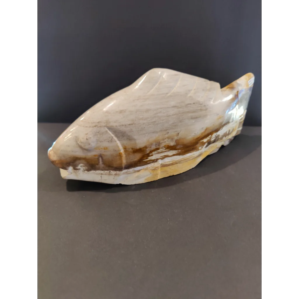 Polished petrified wood fish sculpture with natural white and brown veining
