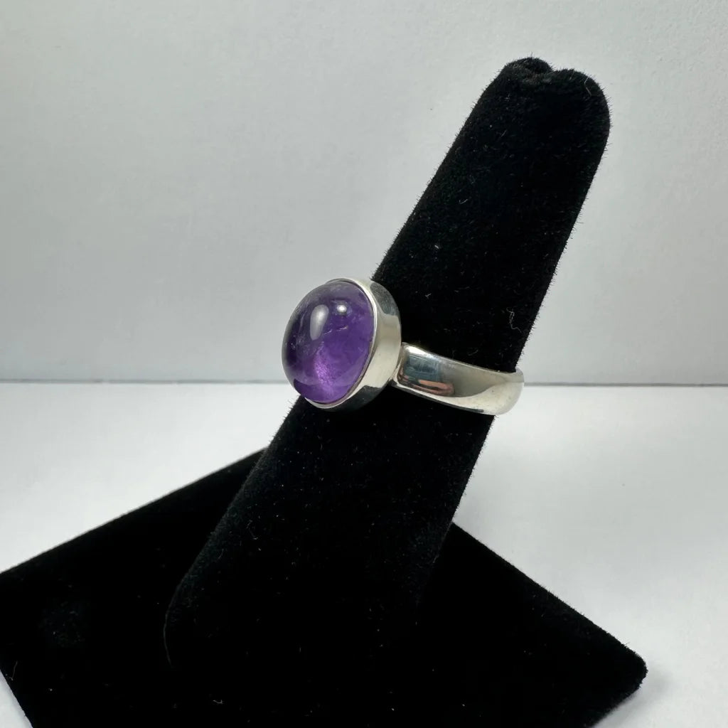 Sleek silver amethyst ring with oval purple stone in polished bezel